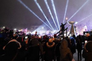 Amanda Demmerle, 2021 Athlete of the Year, lights the Opening Ceremony cauldron at the Empire State Winter Games on Mirror Lake in Lake Placid, N.Y., on Thursday, February 3, 2022. (Photo by Toluwanimi Fajolu/Newhouse School)
